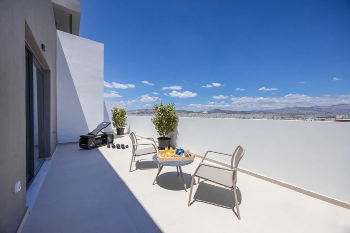 Sokio Attiki aparthotel terrace with chairs and Portable exercise equipment